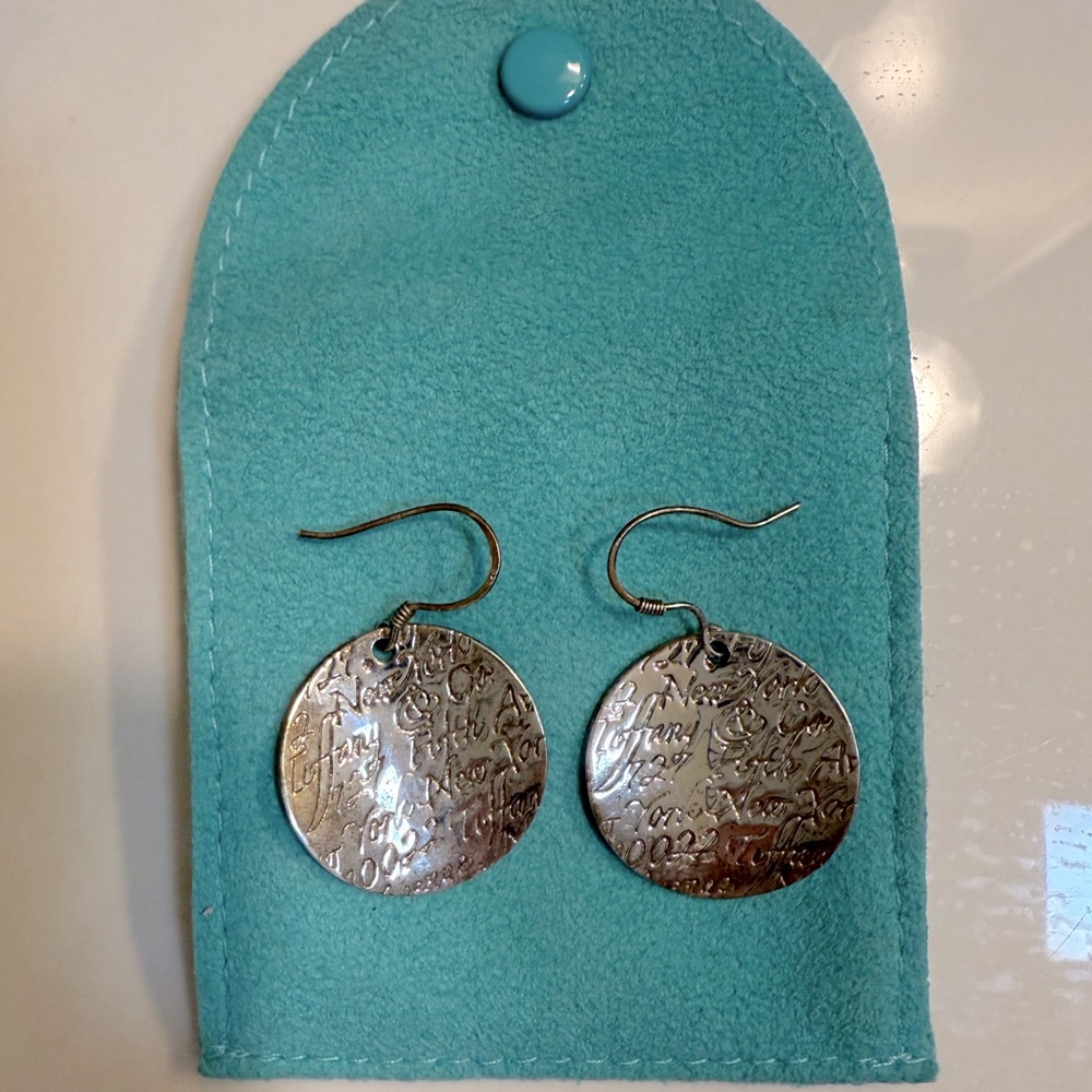 Authentic Tiffany & Co notes large wavy circle dangle hook earrings.